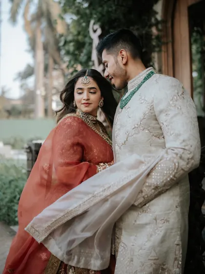 A candid moment between the couple, sharing a look of love. This shot captures the natural and easy chemistry between them.
