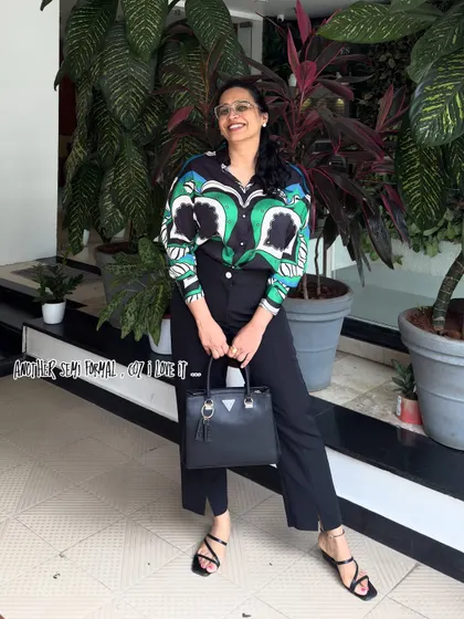 A bold and stylish semi-formal look featuring a printed shirt and black trousers. This outfit is perfect for a creative professional, showcasing a confident and fashion-forward style.