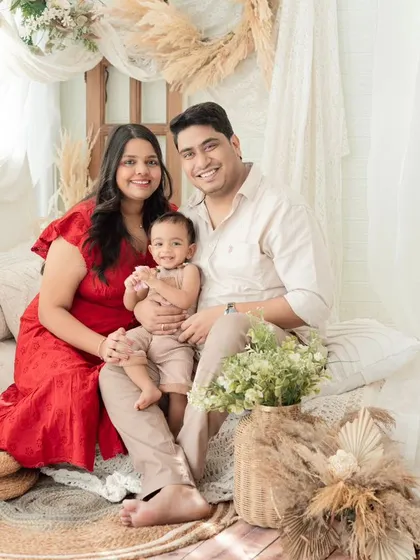 A cozy family photo in our boho-themed studio setup. The warm, natural tones and textures create a relaxed and inviting atmosphere for family portraits.