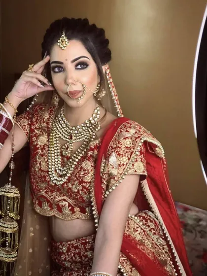 For a truly royal look, I offer layered sets like this one. It features a Kundan choker paired with a long Polki rani haar, maang tikka, and kalire, creating a stunning silhouette for any bride.