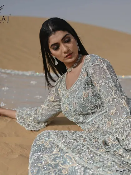 A close-up of the glamorous sea-green Indo-western double-layered bridal silhouette, revealing its magnificence.