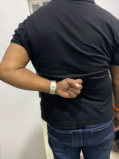 Here is the significant improvement in Mr. Hukum's ability to reach behind his back after several sessions, showing increased flexibility and reduced pain.