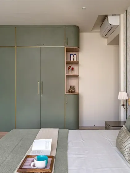 This view shows the custom-built wardrobe with its curved edge and gold inlay details. I build wardrobes at my factory and install them on-site, ensuring a perfect fit and a high-quality finish that matches the rest of the room's furniture.