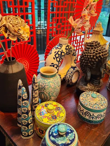 A close-up of the props used for the Chinese food festival, including patterned vases, wooden flowers, and decorative boxes. Attention to these small details is key to creating an authentic themed environment.