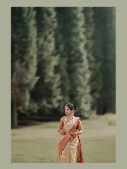 A portrait of the bride against a backdrop of tall trees, creating a sense of tranquility and elegance.