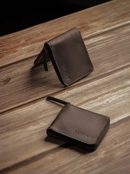 Two Glidinggear wallets arranged on a wooden surface, showing the product from different angles.