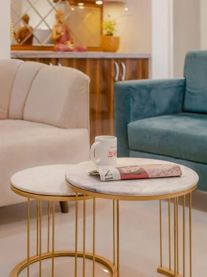 A close-up of the nested coffee tables with marble tops and gold-finished wireframes, adding a touch of modern elegance to the living room.