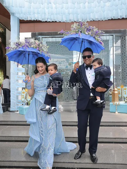 A stylish family entrance, complete with custom floral umbrellas. This shows how I coordinate even the smallest details to match the event's theme and color palette, ensuring a cohesive and elegant look.