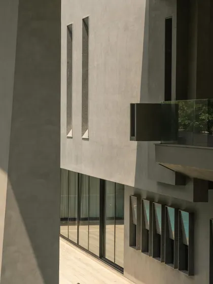 Various exterior perspectives that capture the dynamic geometry and the dance of light and shadow across the concrete surfaces throughout the day.