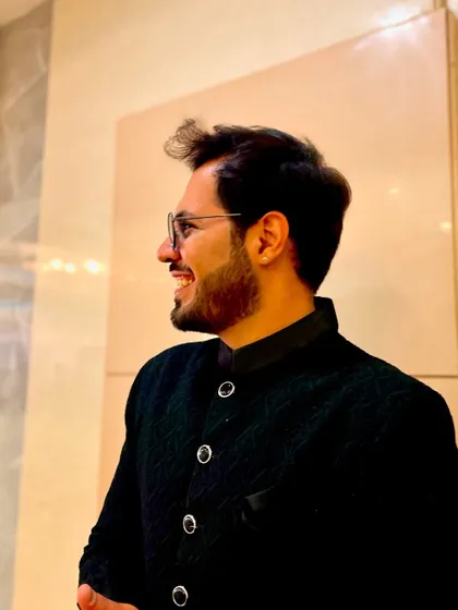 A happy, smiling profile in a classic black bandhgala, showing a more sophisticated side.
