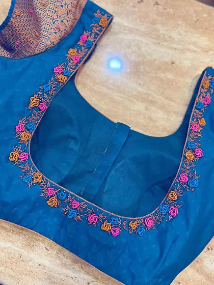 A duplicate image showing the French knot embroidery on the neckline.