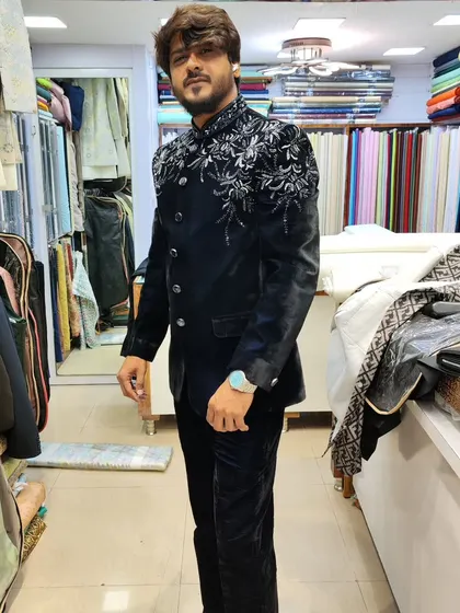 A client wearing a navy blue velvet Jodhpuri suit with wonderful silver embroidery on the shoulders. This is a perfect party wear outfit for a winter wedding.