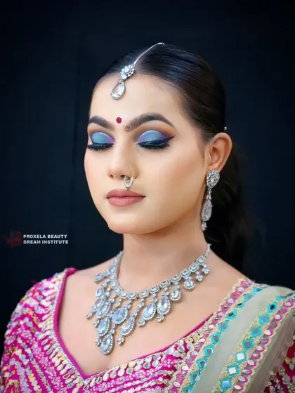 A close-up on the dramatic eye makeup. The blend of deep blues and a sharp wing creates a mysterious and captivating look, perfect for an evening event.