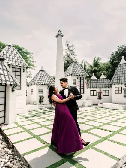 For couples looking for something unique, a pre-wedding set offers a world of creative possibilities. Here, a whimsical, European-style village backdrop provides a playful and fairytale-like setting for a romantic dance.