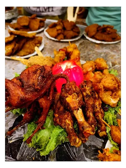 Another angle of our abundant starter platter, featuring whole fried quail, chicken drumsticks, and other crispy delights. It’s a testament to our belief that when it comes to food, more is more.