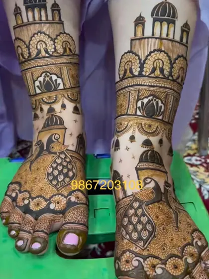 A beautiful and intricate foot design showcasing peacocks and palace architecture, matching the grandeur of a full bridal mehandi.