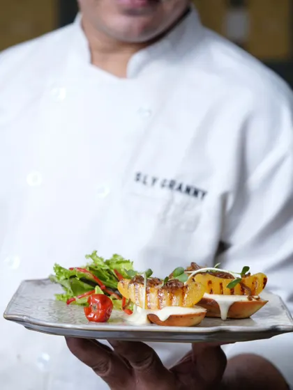 My chef presenting a plate of grilled peach tartlets. Good things come in fours, and with a side of sass.