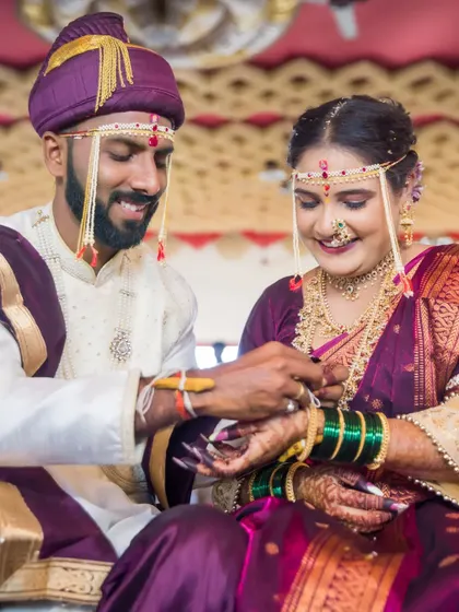 A sweet moment during the wedding rituals, as the groom helps the bride with her bangles.