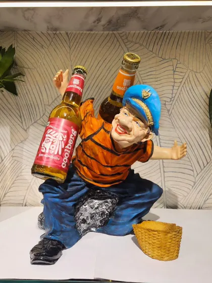 Another one of our quirky bottle holders, this one featuring a cheerful man carrying two bottles. A fun and functional gift for any occasion.