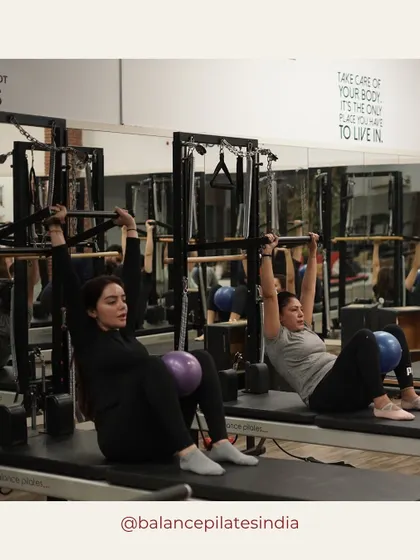 A glimpse of a group class in session. Here, clients are using the magic circle to engage their inner thighs and core.