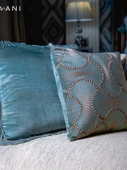 Incorporatethe soothing hues of teal into your decor. These velvet cushions, one with elegant fringe and the other with coppery geometric embroidery, add a touch of sophisticated color to any sofa.