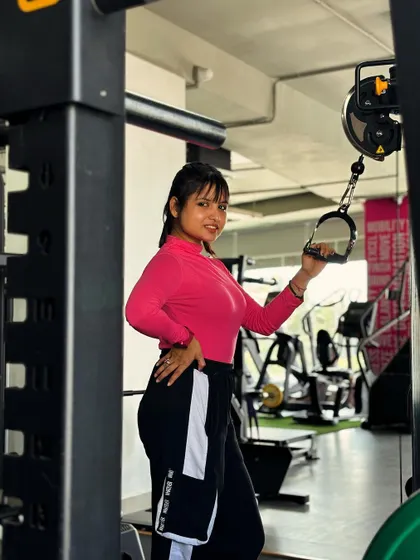 Smiling while getting ready for a tricep exercise. I believe that you should enjoy your workouts and find joy in the process of getting stronger.