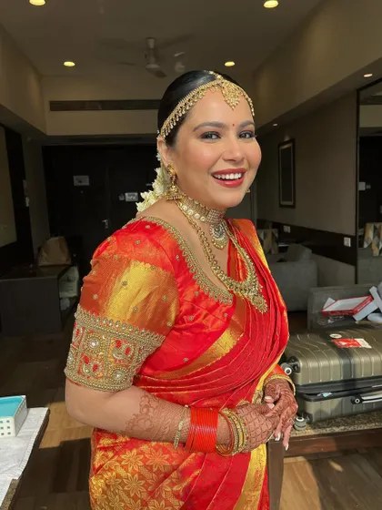 A happy bride, glowing with excitement. The makeup is flawless, and her smile lights up the room.