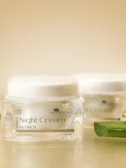 A styled shot of Natuos 365 Night Cream with slices of cucumber, indicating a key ingredient and suggesting a cool, refreshing effect.