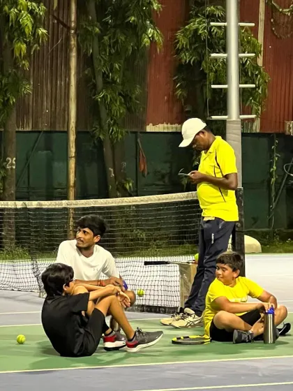 A coach takes a moment to chat with players during a break. These informal interactions help build trust and strengthen the coach-player relationship, which is crucial for effective training.