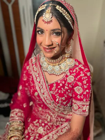A beautiful smiling portrait of Jinal. Her makeup is soft yet defined, a perfect balance for a traditional wedding ceremony.