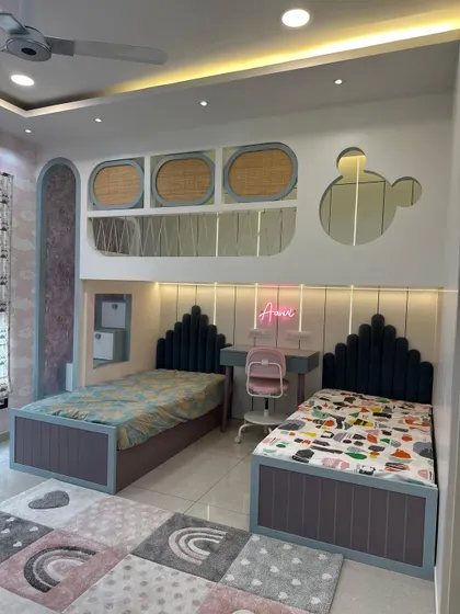I love designing spaces for the little ones. This shared kids' bedroom features custom twin beds, a dedicated study area, and playful design elements like a Mickey-shaped mirror, creating a room that is both fun and functional.