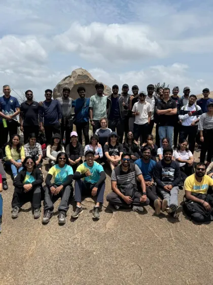 A large corporate group taking a well-deserved rest on the rocky slopes of Uttari Betta. We can accommodate teams of various sizes for our custom day treks from Bangalore.