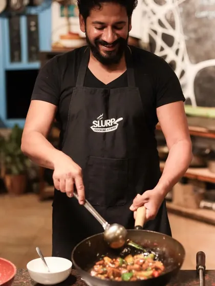 A participant smiles as he masters a new cooking technique. Our goal is to make learning enjoyable and empowering for every home cook.