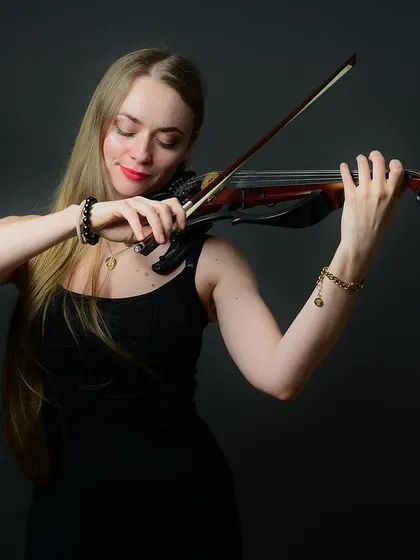 A portrait of a musician lost in her art. Capturing these moments of intense focus and passion is what makes a personality portrait truly special.