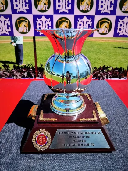 The Saddle Up Cup, a gleaming silver vase-shaped trophy.