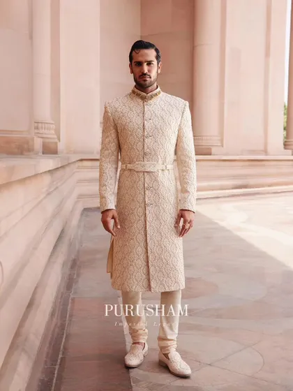 A classic, belted sherwani from my 'Takht' collection. The all-over geometric pattern is a subtle yet powerful detail, creating a look of quiet confidence and excellence.