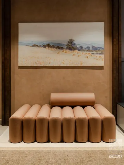 A unique and modern daybed-style sofa with tubular cushions in a soft terracotta art leather. This piece is designed for those who appreciate sculptural, statement furniture.