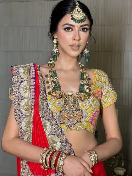 A frontal view of this royal look. The makeup is clean and sharp, allowing the magnificent jewelry and outfit to shine.