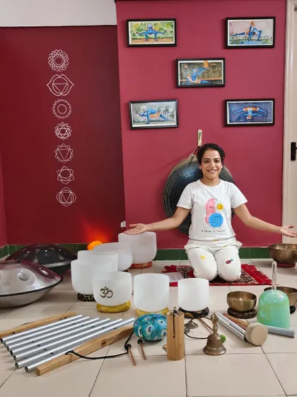 A student joyfully surrounded by the instruments she has mastered during her training. Each graduate is now prepared to create more harmony in the world, one vibration at a time.