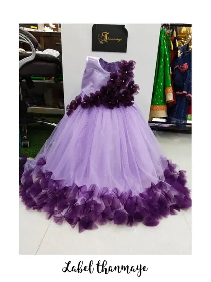 I designed this lavender gown with a cascade of wine-colored flowers on the bodice and a ruffled hem.