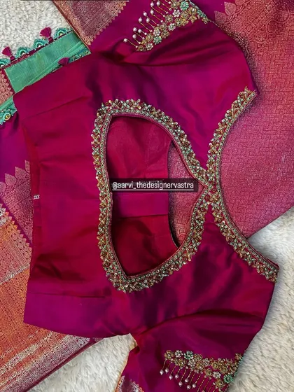 A beautiful pink blouse with a keyhole back, detailed with intricate bead and stone work. Perfect for a grand celebration.