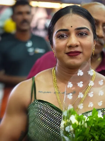 A close-up shot from an event, holding a bouquet. The support from the community is what fuels my journey.