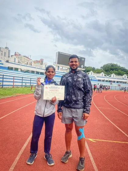 Silver in the 600m run. Our Under-14 athlete celebrates her achievement with her coach on the track after a gritty performance.