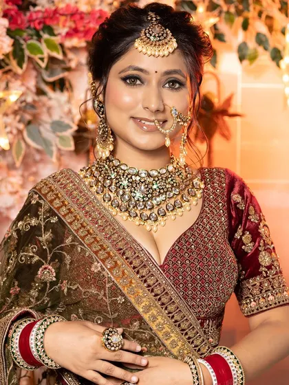 A full view of the bride, showing how the entire look comes together with a beautiful floral background.