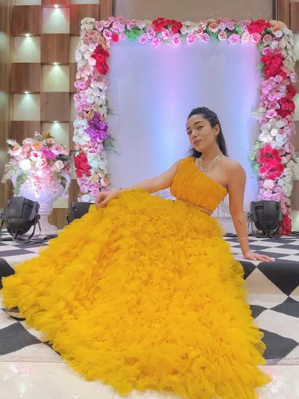 A stunning yellow ruffled gown for a Haldi or Mehendi function. I love wearing bright, happy colors that match the festive mood of the celebrations.