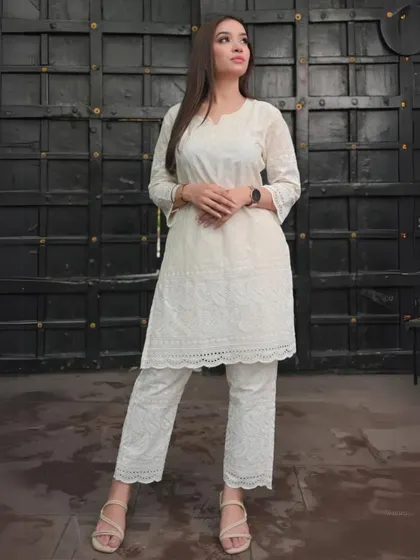 An all-white Chikankari kurta and pant set. This showcases the beauty of traditional Lucknowi embroidery in a clean, modern silhouette that is both elegant and understated.