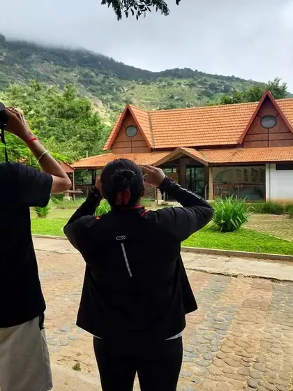 Two guests use binoculars to spot birds from the resort grounds. You don't have to go far to see some of our amazing feathered residents.