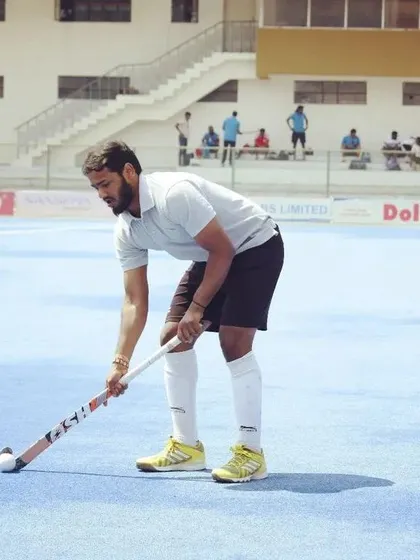 A player demonstrates perfect form while practicing on the blue AstroTurf. We train our players to be comfortable and skilled on all surfaces.