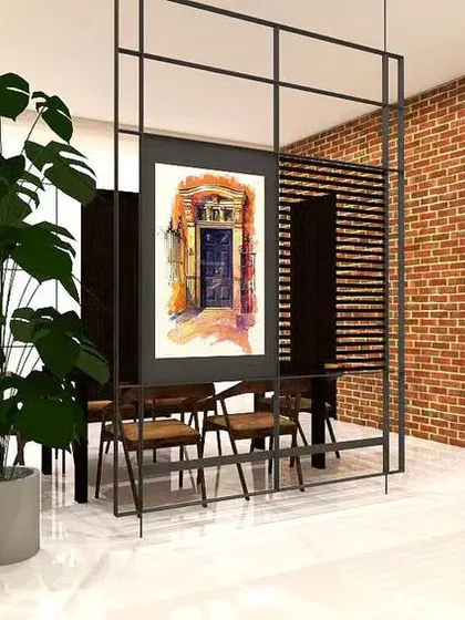 An exposed brick wall brings so much character and texture to this dining space. I used a metal and glass partition to create a visual separation from the living area while maintaining an open feel. The large artwork adds a personal touch.