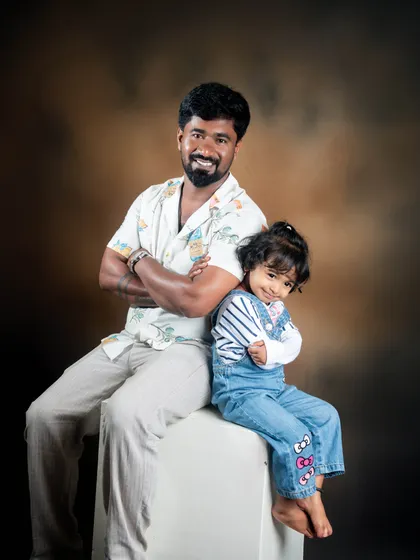 The bond between a father and his daughter is truly special. This studio portrait uses simple, classic lighting to highlight a quiet, loving moment between them.